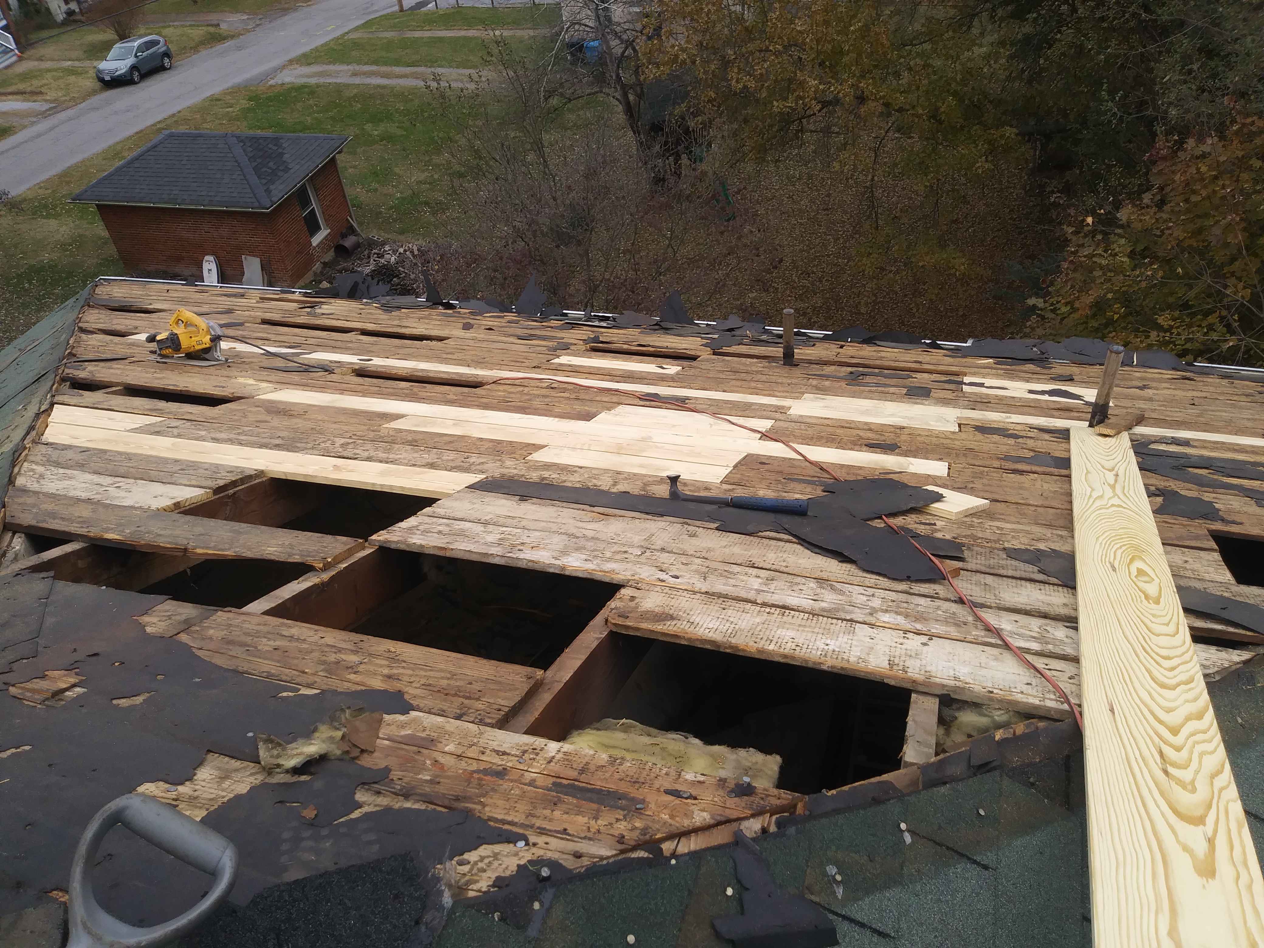 Wood being replaced on an opened roof